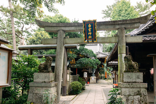Sacred torii gate at Shiramine Shrine Kyoto beneath soft natural daylight in quiet urban district, Kyoto, Japan 