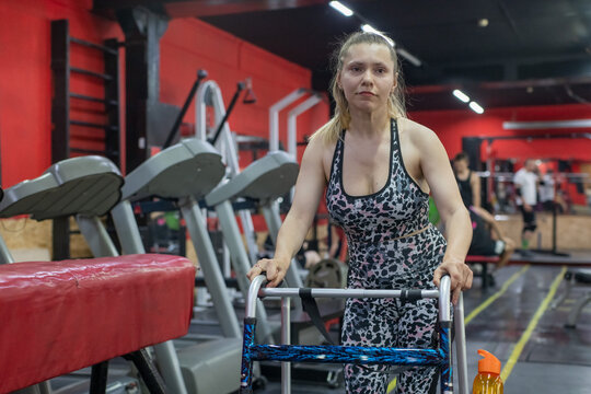 A woman with cerebral palsy works out in the gym. 