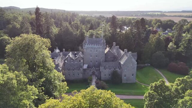 aerial drone video of 15th-century medieval Cawdor Castle showing its central stone tower house,  in Nairnshire, Scottish Highlands, Scotland