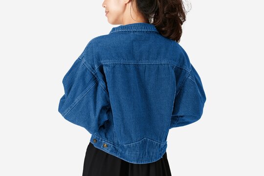 Blue denim jacket worn by woman on white background