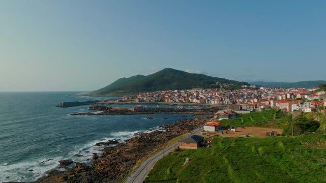 Sweeping aerial perspective of A Guarda, Spain, where the dramatic meeting of rugged Atlantic coastline and historic seaside architecture creates a profound sense of peaceful discovery and connection