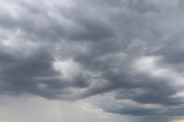 Fototapeta premium Dramatic storm clouds over a dark landscape