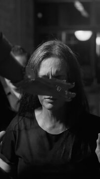 Emotional female worshiper experiencing powerful spiritual renewal and divine intervention while receiving pastoral prayer with hands on forehead in black and white
