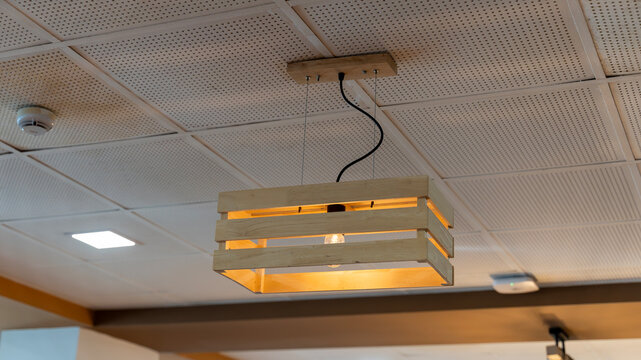 Wooden hanging ceiling light fixture in a modern indoor interior