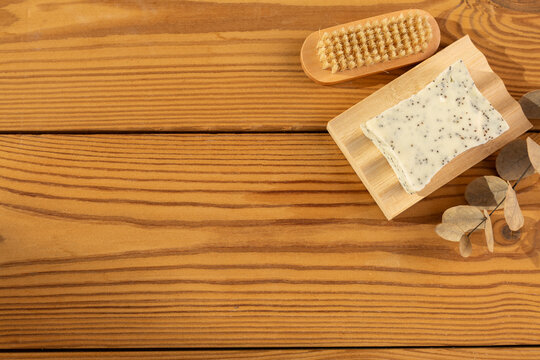 Natural herbal soap with scrub. Handmade soap bars on a wooden background. Space for text. 