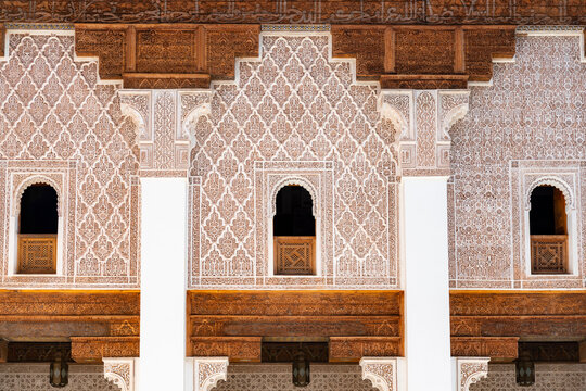 Ben Youssef Madrasa displaying traditional Islamic architecture with detailed stucco patterns and carved wooden elements creating a captivating display of Moroccan craftsmanship