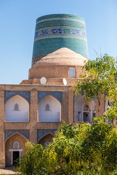 Interior of the Mohammed Amin Khan Madrassah in the city center of historic Khiva, with the Kalta Minor Minaret in the background.