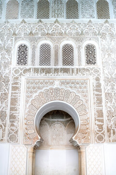 Ben Youssef Madrasa displaying elaborate Islamic stucco carvings geometric patterns and traditional archways representing Moroccan heritage and historical architecture in Marrakech