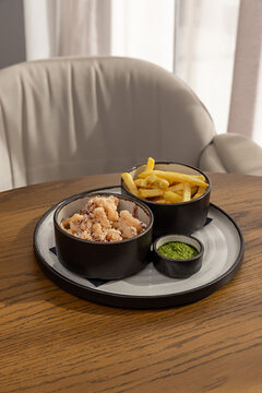 Deep fried calamari served with french fries and green pesto sauce