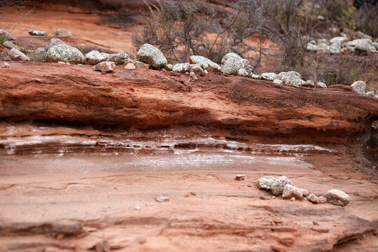 Detailed view of stratified red sandstone layers with salt deposits