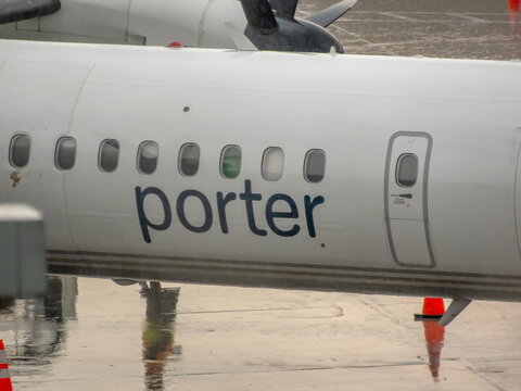 Ottawa, Ontario, Canada. Sep 9, 2026. Close-up view of Porter Airlines aircraft fuselage with logo and passenger windows at airport gate.