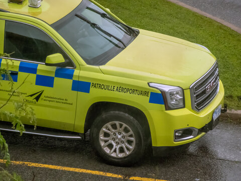 Ottawa, Ontario, Canada. Sep 9, 2026. High angle view of yellow Ottawa International Airport Authority security patrol truck parked on asphalt.