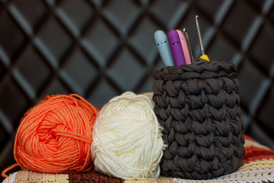 Handmade crochet blanket with yarn balls and hooks. Crochet hobby for mental wellbeing, digital detox, relax