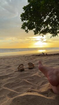 Relaxing person enjoying a peaceful sunset on a sandy beach