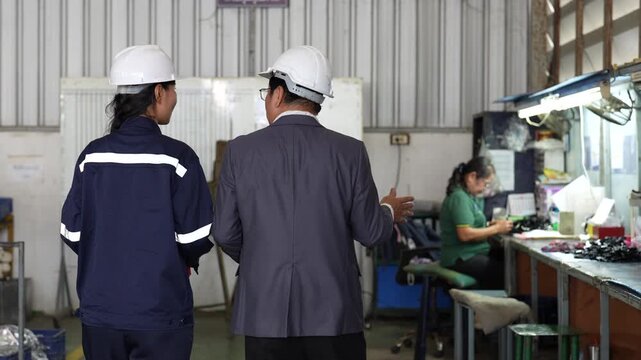 Industrial worker supervisor safety helmet factory female technician workstation teamwork manufacturing production workplace workshop protective clothing industrial facility
