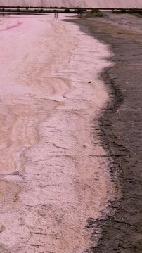 Pink lakes salt marshes, salt mining medieval town of Aigues-Morte, Camargue, France. High quality 4k footage