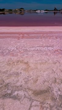 Pink lakes salt marshes, salt mining medieval town of Aigues-Morte, Camargue, France. High quality 4k footage