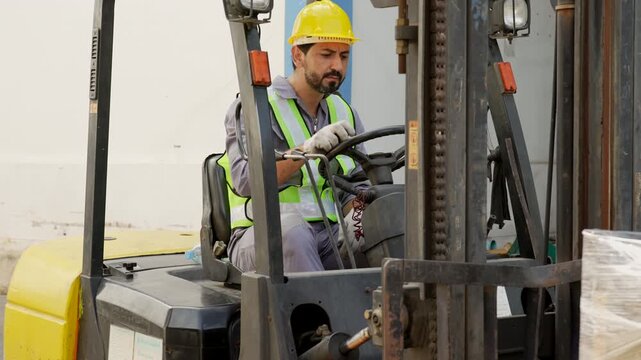 Forklift Operator Loading Wrapped Pallet in Warehouse, Industrial Logistics Material Transport, Workplace Safety Equipment, High Visibility Vest, Focused Handling Operations