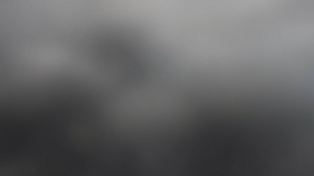Moving abstract blurred charcoal grey ink in water background, slow calm gradient for neutral corporate overlays