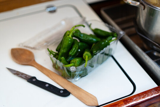 Fresh green padron peppers in a punnet on the galley worktop of a sailing yacht off La Palma