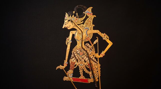 Traditional Javanese Wayang Kulit Shadow Puppet Isolated Against a Plain Black Background Featuring Intricate Hand Carved Leather Craftsmanship