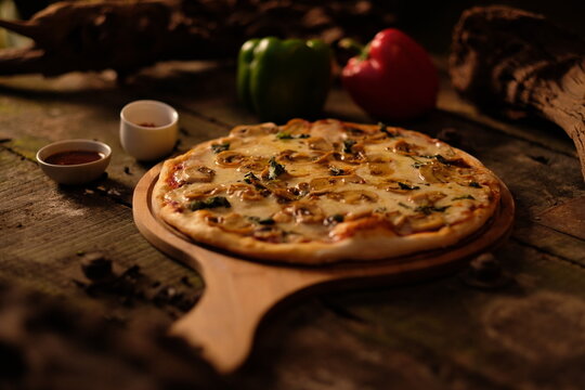 Freshly Baked Cheese Pizza Served on a Wooden Paddle Board in a Rustic Setting