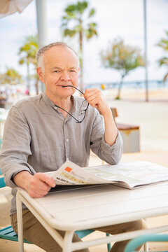 An elderly gentleman's habit of reading the news in the morning
