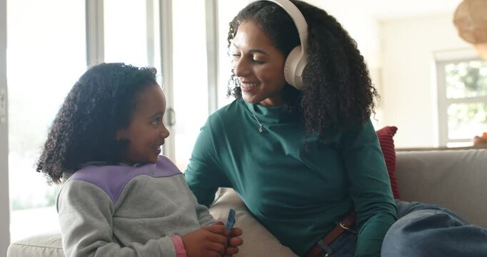 African American woman and child leaning, pointing, smiling, laughing with headset
