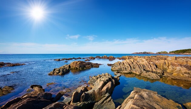 scenic view of rocky tidal pools and calm sea under a bright blue sky tranquil coastal landscape copy space