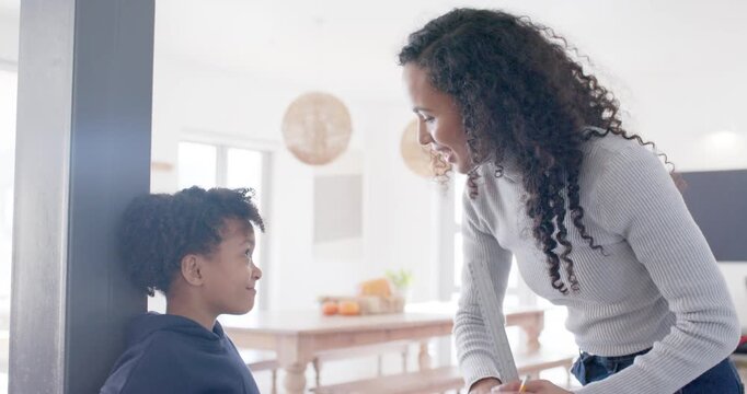 African American mom marking height with pencil on pillar guiding child pressing switch at home
