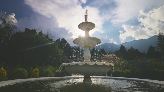 Sunlit Fountain with Water and Mountainous Background