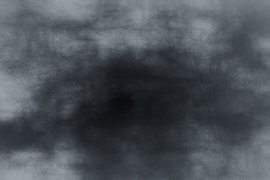Abstract dark gray smoky texture background with subtle grunge effect ideal for overlay, blending mode, or atmospheric design elements.