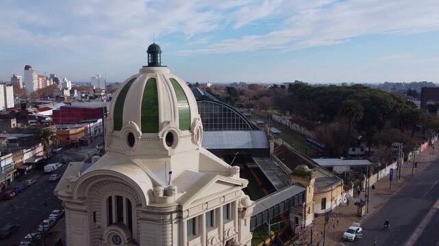 Partial aerial orbit shot around the dome of La Plata Train Station revealing the glass arch canopy covering the platforms in Argentina.