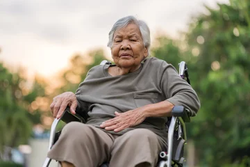 senior woman suffering from stomach ache while sitting in wheelchair at park © geargodz