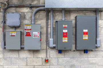 Commercial electrical transfer switch and solar panel PV disconnect system on concrete wall in USA © Andrei Liashchou