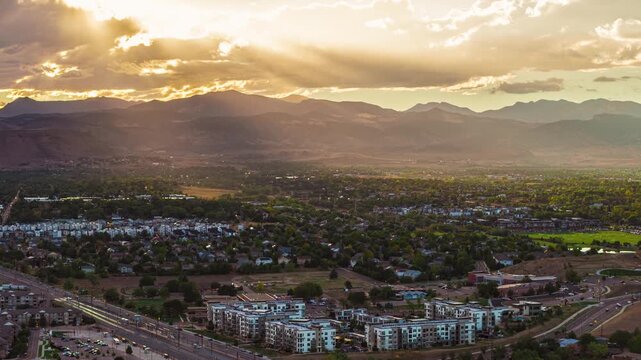 Sunset by the mountains with sun rays drone hyperlapse Denver Golden Colorado 4K