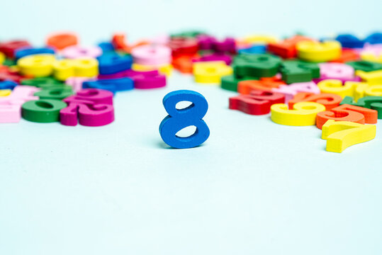 Blue number eight among colorful numbers representing numbers and education
