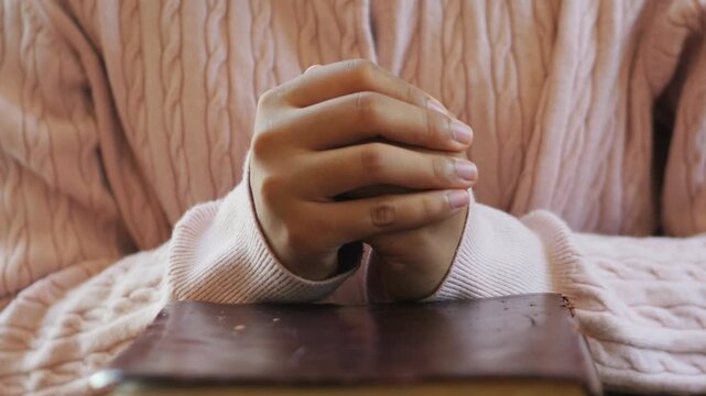 hands pray to God with the bible