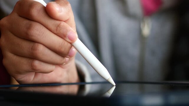 Close up of woman hand using stylus pen digital tablet, e-signing on screen, electronic signature concept