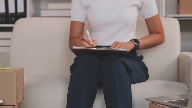 Portrait of Starting small businesses SME owners, two Asian woman check online orders Selling products working with boxs freelance work at home office, sme business online small medium enterprise