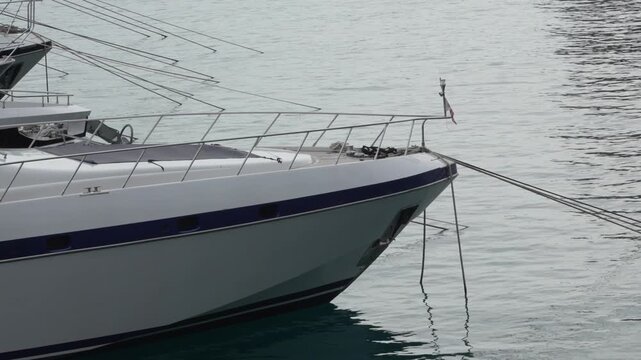 A sail boat floating in Port Hercule in Monaco