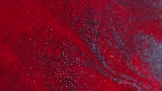 Vivid wave. Splatter fluid. Defocused red silver vibrant color sparkling ink liquid bright texture spreading on abstract creative background.