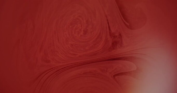 Defocused dye texture. Color water pigment. Red orange swirl paint bright fluid glitter liquid art floating on abstract background.