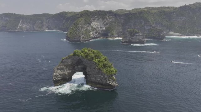 Aerial view of the sea caves along the coastline of Nusa Penida, Indonesia