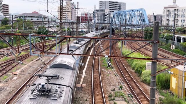 Tokaido Line train emerging through a sweeping curve in the dense railway network near Tsurumi, Yokohama