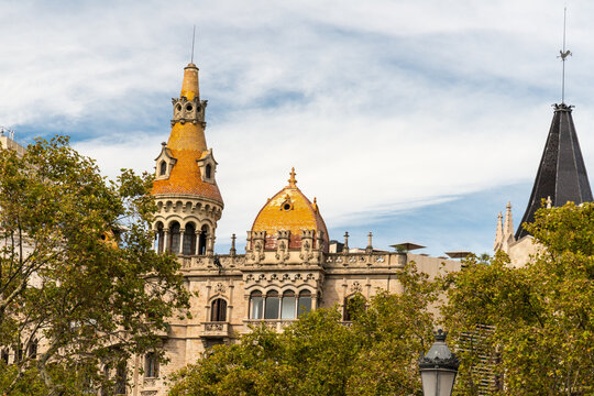 Spain, Barcelona, Casa Rocamora.  Historic buildings in the Gothic style. Commissioned by the powerful Rocamor family, they feature five domes covered in bright orange ceramic tiles.