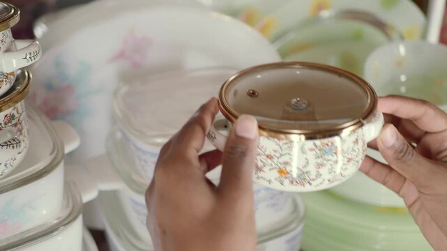 hand pick kitchenware from a shelf.