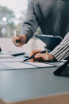 Business professional analyzing financial data on digital tablet dashboard with calculator and laptop, representing accounting software, ERP system integration, performance monitoring.