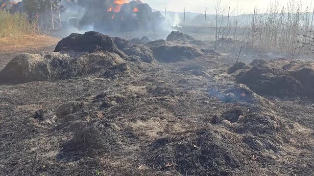 Fire in a village. Hay bales.