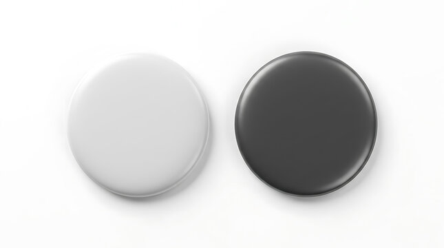 Two blank round 3 d buttons one white one dark grey